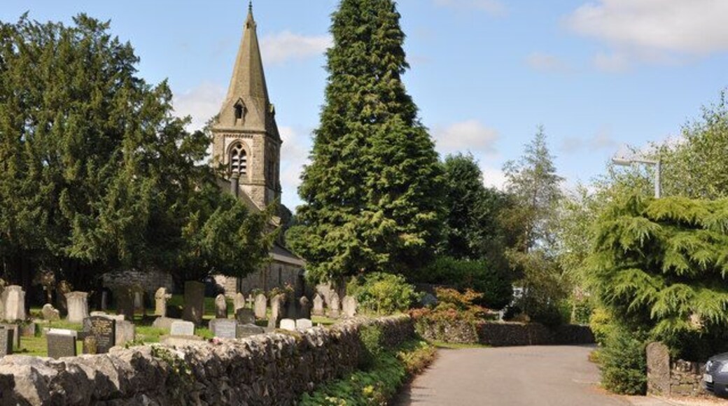Church Walk, Parwich, Derbyshire, with the tower and spire of St Peter's parish church on the left