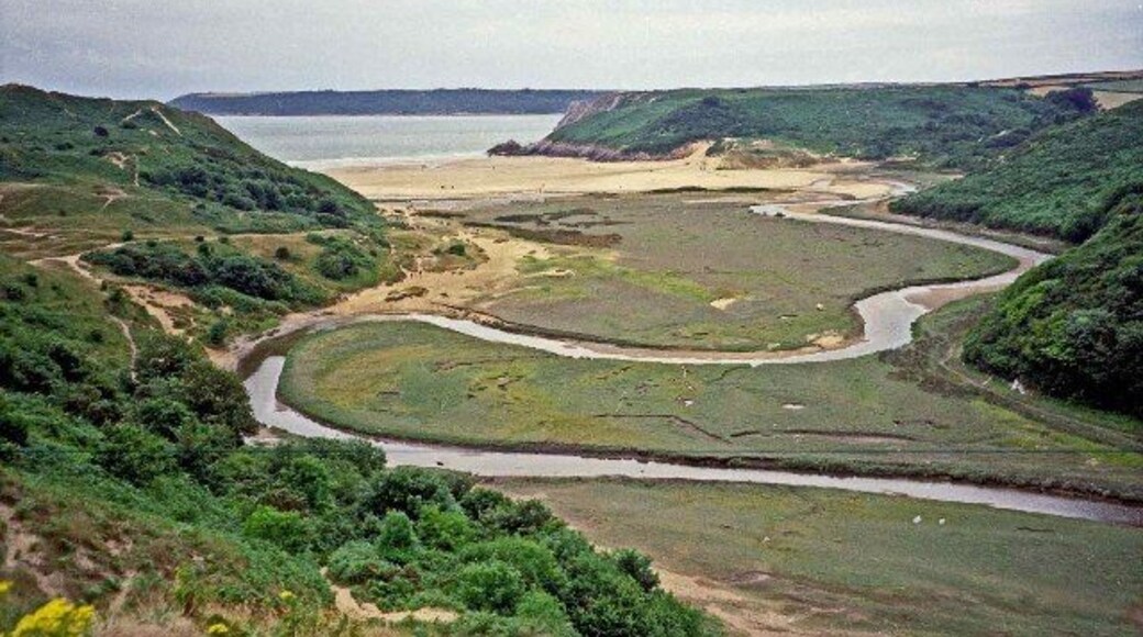 The meandering Pennard Pill. View of the Pennard Pill as it meanders towards the sea in Three Cliffs Bay, taken from near the ruined chapel and castle.