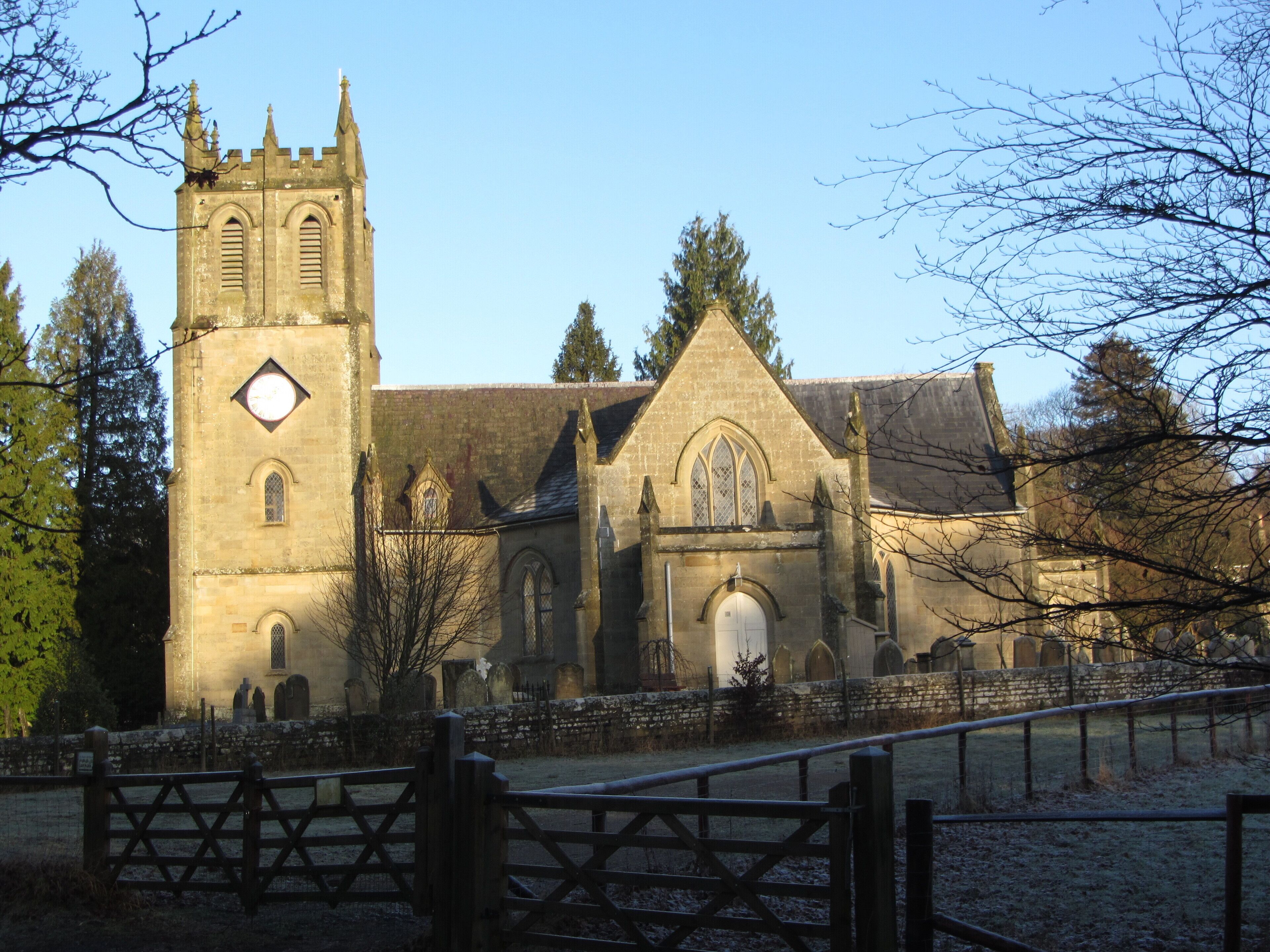 A historic church with a tall tower and arched windows.