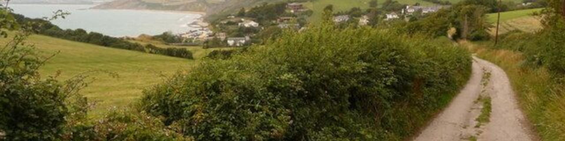Osmington Mills: the road to Upton Fort The village of Osmington Mills is visible in the distance, while we look along the road that leads to Upton Fort, just behind us.