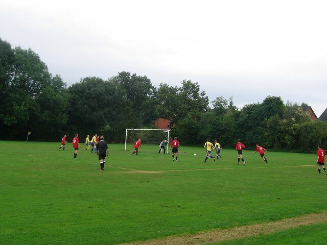 Orleton playing fields. "Olton" vrs The Bell (A Leominster pub side, in yellow). There is a large sports field behind the village hall. Some of the newer houses can be seen behind the goal.