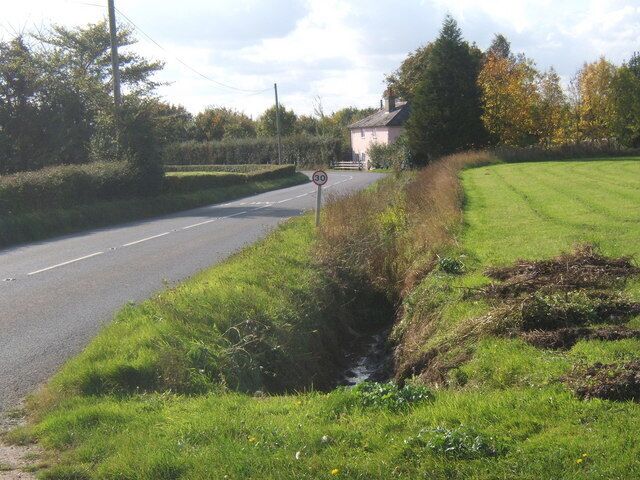 B1113 towards cottage by a corner Just one of many bends on the B1113.