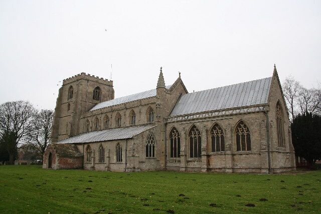 A large stone church with a bell tower and arched windows.