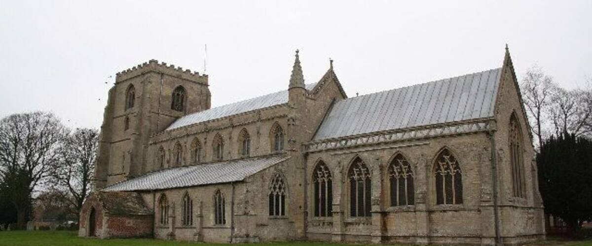 A large stone church with a bell tower and arched windows.