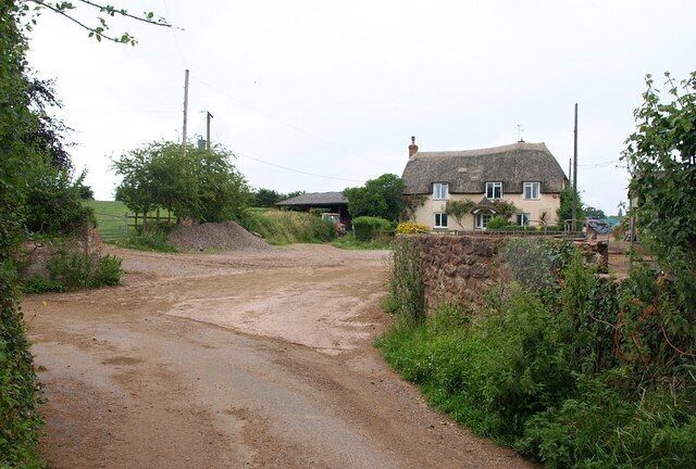 Broom Farm The thatched farmhouse, seen from a bend in the winding Broom Lane.