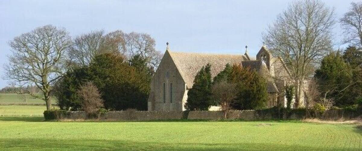 Farmland beside the Church of England parish church of All Saints, Nuneham Courtenay, Oxfordshire. This is Nuneham's third parish church and was built in 1872. The previous church is a mile away in Nuneham Park. The church is aligned slightly to the north of an easterly bearing.