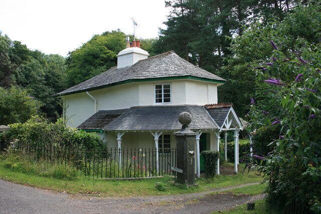 Lodge House, Avonwick. This probably Victorian lodge cottage is at the drive entrance to Black Hall in Avonwick, although it doesn't seem used as a drive nowadays. It is diametrically opposite to the Toll House across the main road bridge over the River Avon, and the designs do mirror each other, it can just be seen to the left in the geograph image of the Old Toll House 39583. Its charming and reflects the quiet pace of its time, but its probably quite noisy as it is next to a "c" class road [once a "B" road downgraded in an unsuccessful attempt to reduce traffic flows] that has become a rat run between the A38 and Totnes with an alarming and increasing record of traffic accidents, usually speed related.