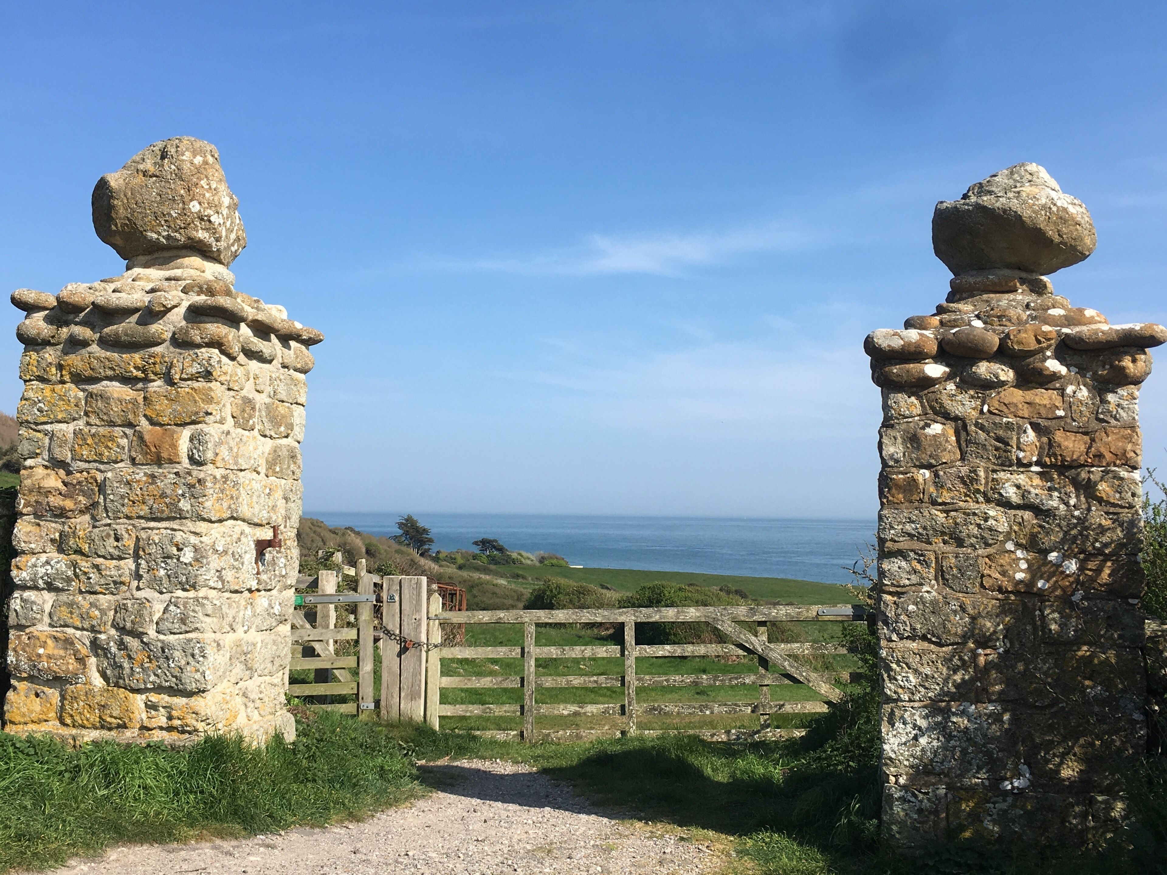A stone gate leading to a coastal view.