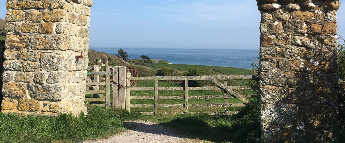 A stone gate leading to a coastal view.