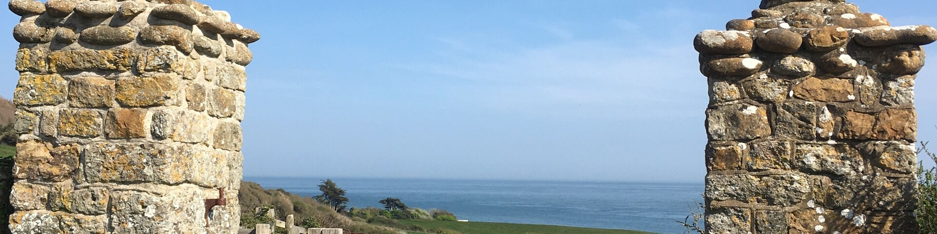 A stone gate leading to a coastal view.