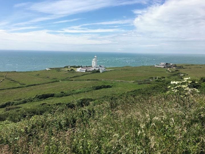 St. Catherine's Lighthouse is one of the oldest lighthouse locations in Great Britain. The first lighthouse was established on St. Catherine's Down in 1323 on the orders of the Pope, after a ship ran aground nearby and its cargo was either lost or plundered. Once part of St. Catherine's Oratory, its octagonal stone tower can still be seen today on the hill to the west of Niton. It is known locally as the "Pepperpot"