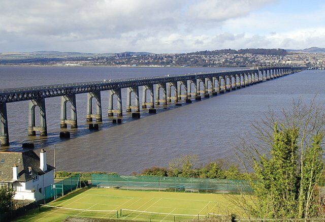 Tay Bridge from Wormit Designed by WH Barlow and constructed by William Arrol this 3500 metre long second bridge, built 60 feet upstream of the original bridge, opened for service in July 1887. The stumps of the original can clearly be seen in this low tide shot.