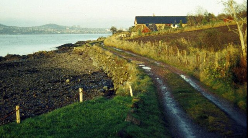 Balmerino. The village street in Balmerino peters out into this track which leads to a few cottages on the shore of the Firth of Tay. Dundee can be seen in the distance on the opposite bank .