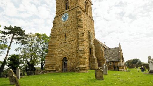 This ironstone church dates back to the 11th century and was restored in 1805 and 1874. There is a western tower, nave, chancel, vestry, and south porch. The west tower is Saxo-Norman, the ironstone being very weathered. The top part is 15th century, having a plain parapet with 19th-century pinnacles. There are three bells. The tower was restored in 2011. The tower arch is tall and was restored in the 1500s. The Royal coat of arms above it dates from post 1837, and is made of cast metal. Most of the rest of the church dates from the 1874 rebuilding with some mediaeval masonry retained. On the outside of the chancel wall is an early 12th century panel with various geometrical decorations. The fittings are all 19th-century, and the floor is paved with Minton tiles. The small organ is by Cuthbert of Hull from 1877. There are several stained-glass windows, dating from after the time of the 1874 rebuild.