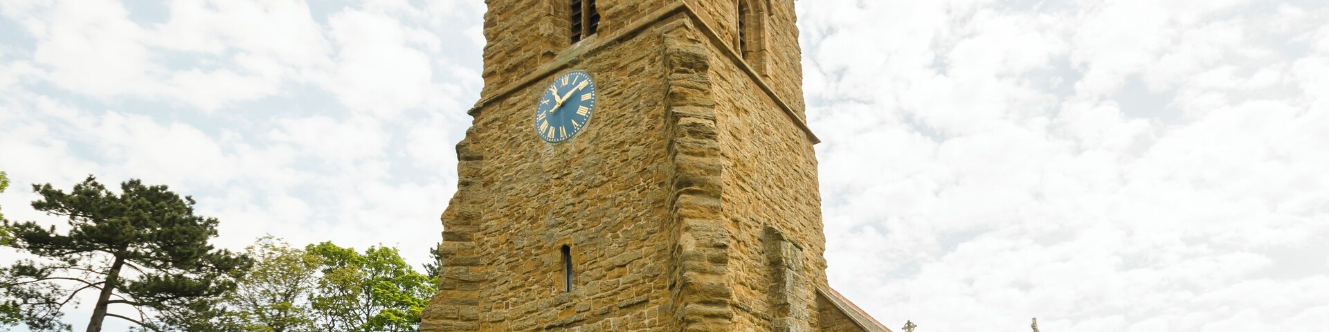 This ironstone church dates back to the 11th century and was restored in 1805 and 1874. There is a western tower, nave, chancel, vestry, and south porch. The west tower is Saxo-Norman, the ironstone being very weathered. The top part is 15th century, having a plain parapet with 19th-century pinnacles. There are three bells. The tower was restored in 2011. The tower arch is tall and was restored in the 1500s. The Royal coat of arms above it dates from post 1837, and is made of cast metal. Most of the rest of the church dates from the 1874 rebuilding with some mediaeval masonry retained. On the outside of the chancel wall is an early 12th century panel with various geometrical decorations. The fittings are all 19th-century, and the floor is paved with Minton tiles. The small organ is by Cuthbert of Hull from 1877. There are several stained-glass windows, dating from after the time of the 1874 rebuild.