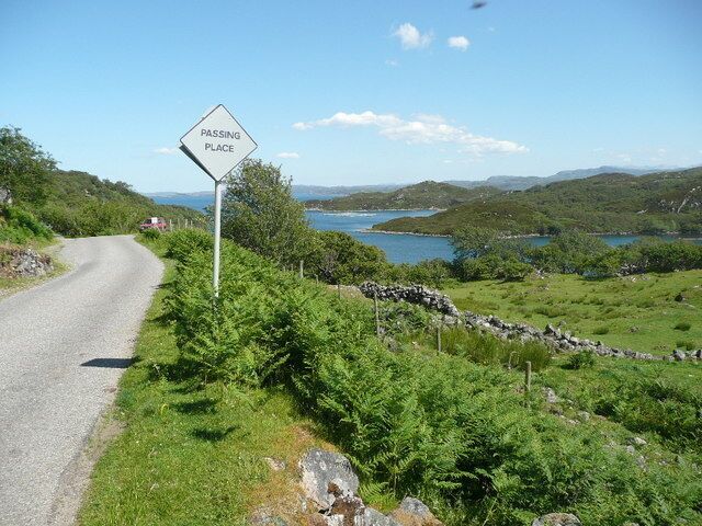 A passing place near Nedd Loch Nedd on the right and Eddrachillis Bay beyond.