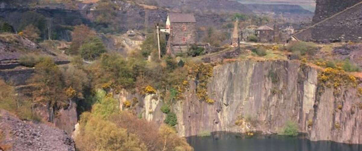Dorothea pumping engine and Penyrorsedd Quarries. The view shows the apparently precarious situation of the engine house between two of the quarry pits. The Penyrorsedd workings can be seen away into the distance. As can be seen in 2106 nature is reclaiming this industrialised area and the view in this 1976 picture would be difficult to replicate today.