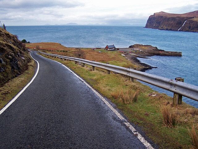 Road to Meanish Pier The road is the B884 which ends at the pier, but as an unclassified road, it continues to loop back through Lower Milovaig. Islands in the Outer Hebrides are visible on the horizon.