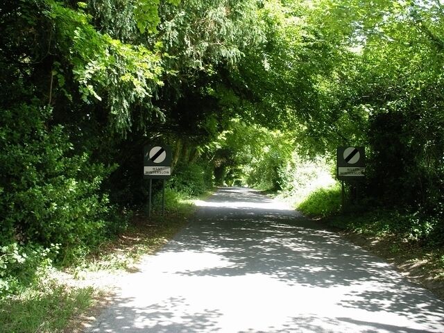 "Leaving village" sign, West Winterslow. Although ubiquitous in France, it's unusual to see "leaving village" signs in England. Here's the exit from West Winterslow, on Weston Lane, which leads to Middle Winterslow.