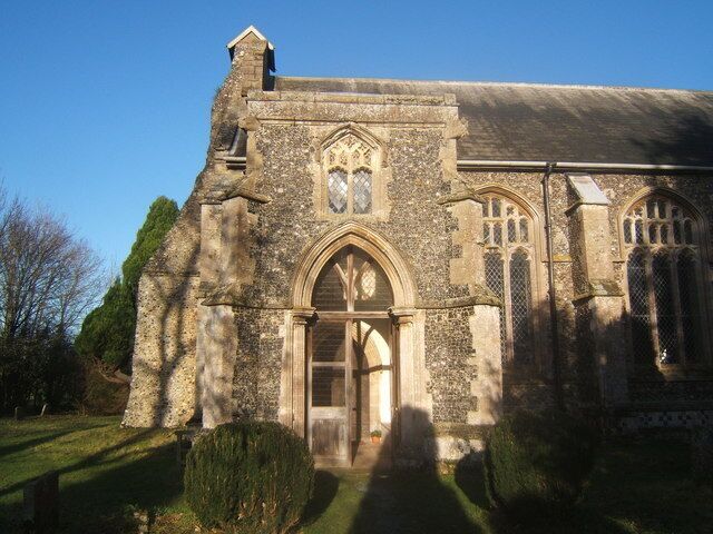 St Mary's Church, Mellis The church boasts a large porch, with fine windows towards the west end of the church. The rest was in shade from the tall trees in the churchyard.