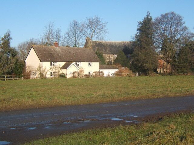 House and glimpse of Mellis church The church appears shy and retiring, set back from the road. But, my word, it is well worth a visit, being a most impressive and distinctive construction.