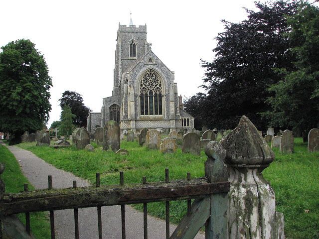 St Mary's church. Viewed across the old churchyard gate on White Street. See > 853183 for a view in the opposite direction. St Mary's tower and nave > https://www.geograph.org.uk/photo/853309 - https://www.geograph.org.uk/photo/853375 date from the 15th century but the chancel - with its monument to Jonathan Dawson, a 19th century rector, in form of an Easter Sepulchre > https://www.geograph.org.uk/photo/853321. The artist is T. Earp, who also sculpted the decoration around the chancel arch > https://www.geograph.org.uk/photo/853314 - https://www.geograph.org.uk/photo/853318 and the stone pulpit - was built in the 1850s by the little known architect, Philip Boyce. The east window is by Hardman & Co (1860s) > https://www.geograph.org.uk/photo/853329. Both north and south aisle east windows display C15 stained glass > https://www.geograph.org.uk/photo/853339 - https://www.geograph.org.uk/photo/853356 - this beautiful selection, mainly by the Norwich School, is the most noteworthy feature of St Mary's but there is also one of only 40-odd seven sacrament fonts dating from the 15th century, which has retained some of the original colouration > https://www.geograph.org.uk/photo/853380 - https://www.geograph.org.uk/photo/853385. The benches have C15 poppyheads, some with carved figures and faces > https://www.geograph.org.uk/photo/853365 - https://www.geograph.org.uk/photo/853369 and a small heart-shaped brass to Robert Alen (d. 1487) is on the chancel floor > https://www.geograph.org.uk/photo/853360. The church is open every day. For more information see: http://www.norfolkchurches.co.uk/martham/martham.htm In the churchyard, just north of the east wall, the grave of David and Anna Hinderer (1827-1870), Anglican missionaries who spent 17 years in Ibadan, Nigeria, can be found > https://www.geograph.org.uk/photo/853302. Anna Hinderer's account "Seventeen years in the Yoruba country" is available as a free download (from the University of Toronto) > https://archive.org/details/yorubacountry00hinduoft
