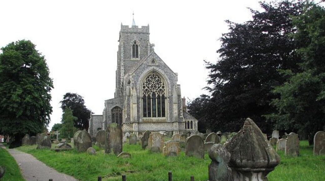 St Mary's church. Viewed across the old churchyard gate on White Street. See > 853183 for a view in the opposite direction. St Mary's tower and nave > https://www.geograph.org.uk/photo/853309 - https://www.geograph.org.uk/photo/853375 date from the 15th century but the chancel - with its monument to Jonathan Dawson, a 19th century rector, in form of an Easter Sepulchre > https://www.geograph.org.uk/photo/853321. The artist is T. Earp, who also sculpted the decoration around the chancel arch > https://www.geograph.org.uk/photo/853314 - https://www.geograph.org.uk/photo/853318 and the stone pulpit - was built in the 1850s by the little known architect, Philip Boyce. The east window is by Hardman & Co (1860s) > https://www.geograph.org.uk/photo/853329. Both north and south aisle east windows display C15 stained glass > https://www.geograph.org.uk/photo/853339 - https://www.geograph.org.uk/photo/853356 - this beautiful selection, mainly by the Norwich School, is the most noteworthy feature of St Mary's but there is also one of only 40-odd seven sacrament fonts dating from the 15th century, which has retained some of the original colouration > https://www.geograph.org.uk/photo/853380 - https://www.geograph.org.uk/photo/853385. The benches have C15 poppyheads, some with carved figures and faces > https://www.geograph.org.uk/photo/853365 - https://www.geograph.org.uk/photo/853369 and a small heart-shaped brass to Robert Alen (d. 1487) is on the chancel floor > https://www.geograph.org.uk/photo/853360. The church is open every day. For more information see: http://www.norfolkchurches.co.uk/martham/martham.htm In the churchyard, just north of the east wall, the grave of David and Anna Hinderer (1827-1870), Anglican missionaries who spent 17 years in Ibadan, Nigeria, can be found > https://www.geograph.org.uk/photo/853302. Anna Hinderer's account "Seventeen years in the Yoruba country" is available as a free download (from the University of Toronto) > https://archive.org/details/yorubacountry00hinduoft