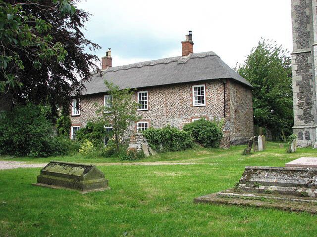 The Vicarage Adjoining St Mary's church; the view was taken from the churchyard. Parts of this brick and flint house with a thatched roof date from the 16th century. Martham has always been a large and busy village with (presently) a post office, a couple of pubs, a supermarket and a variety of other shops, doctors surgery, pharmacy and more than 30 businesses, three schools, a public library, a large playing field with skate park and multi games area and two duck ponds. In 1300 CE the village had a population of about 1,000, and during the Middle Ages Martham provided the monks in Norwich with wheat, barley and peat. C19 directories list a great number of farmers, fishermen, craftsmen and tradesmen such as grocers, butchers, tailers, drapers, shoemakers, basket makers, wheelwrights, joiners, blacksmiths, millers, brick makers, bricklayers, thatchers, glaziers, wherrymen and watchmakers. Most of the bricks seen in older houses were made locally and are of similar appearance, texture and colour. The village green > https://www.geograph.org.uk/photo/853060 is surrounded by C18 houses, some thatched; a fair and general marked used to be held here on the last Tuesday and Wednesday of July. http://www.martham.gov.uk/