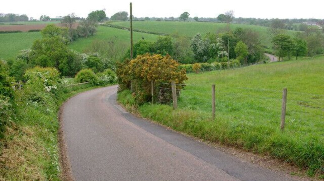 Lane to Marston Montgomery This narrow lane snakes across the peaceful undulating countryside of south west Derbyshire, here dropping down into the valley of one of the many tiny tributaries of the Dove.