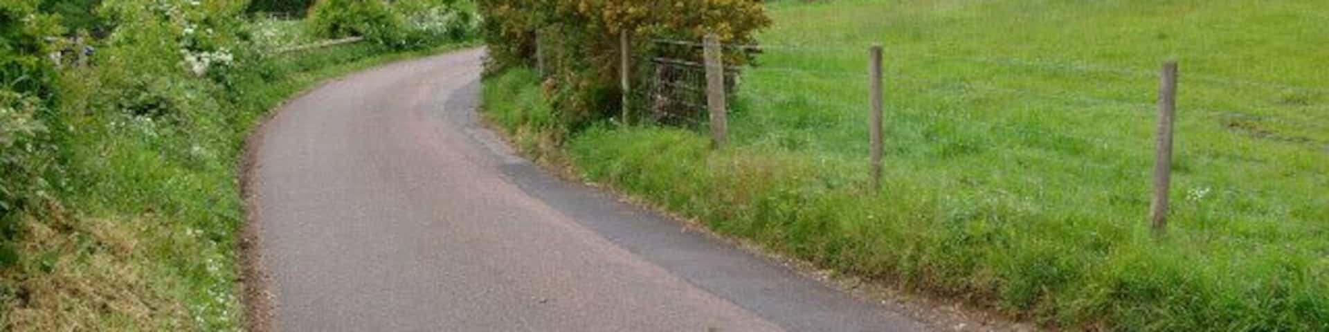 Lane to Marston Montgomery This narrow lane snakes across the peaceful undulating countryside of south west Derbyshire, here dropping down into the valley of one of the many tiny tributaries of the Dove.