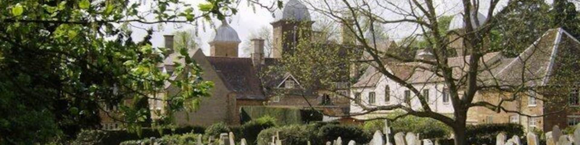 Maidwell Hall Looking across the churchyard at Maidwell Hall with its interesting cupolas. Closer examination was not possible.