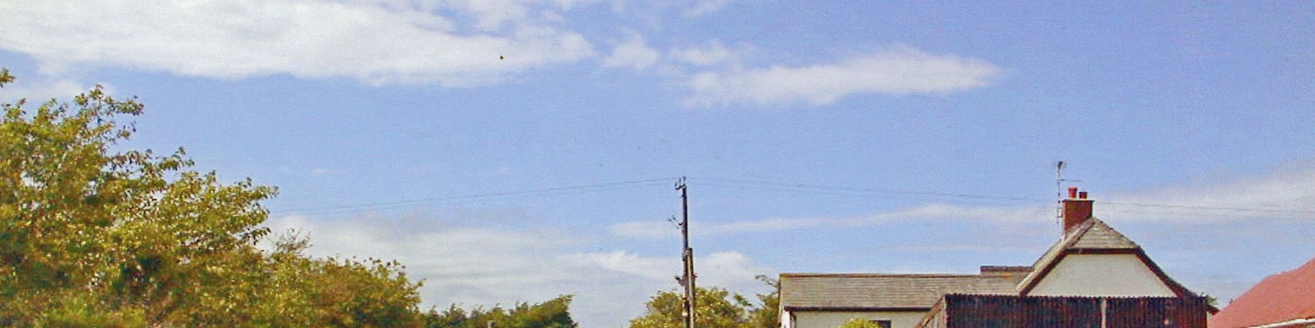 Site of former Maenclochog station, 1992. View northward towards Rosebush and Fishguard along the track-bed of the ex-GWR Clynderwen - Rosebush - Fishguard loop line. The station - actually behind the camera - and this part of the line (Clynderwen - Letterston) had been closed since 25/10/37 for passengers (16/5/49 for goods); passenger services Puncheston - Fishguard had ceased in 1922. However, goods continued Fishguard - Letterston until 1/3/65, also until 1995 by a another branch nearby to RNAD Trecwm and later until at least 2006.