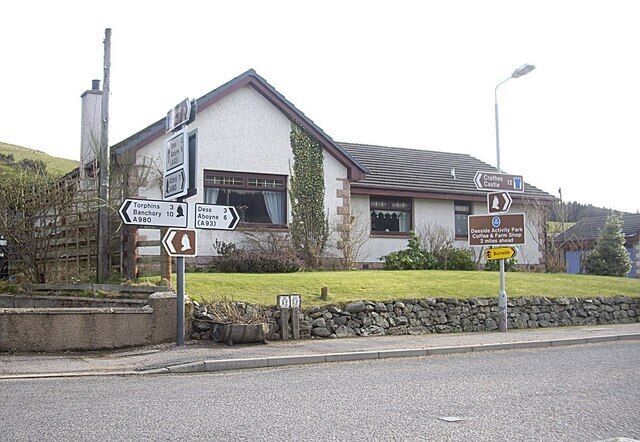 Road junction in Lumphanan Burdened with a slight excess of street furniture!