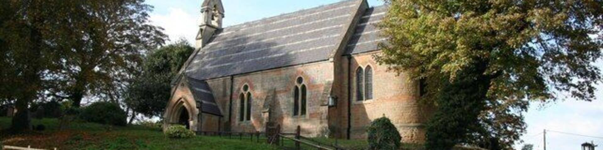 Holy Trinity church, Bulcote Small, immaculately maintained polychrome brick church of 1862 in a prominent position by the A612