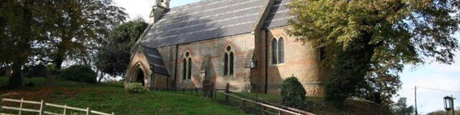 Holy Trinity church, Bulcote Small, immaculately maintained polychrome brick church of 1862 in a prominent position by the A612