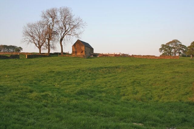 Farmland near Fawfieldhead. The last of the evening sun touches the stone with a mellow golden hue.