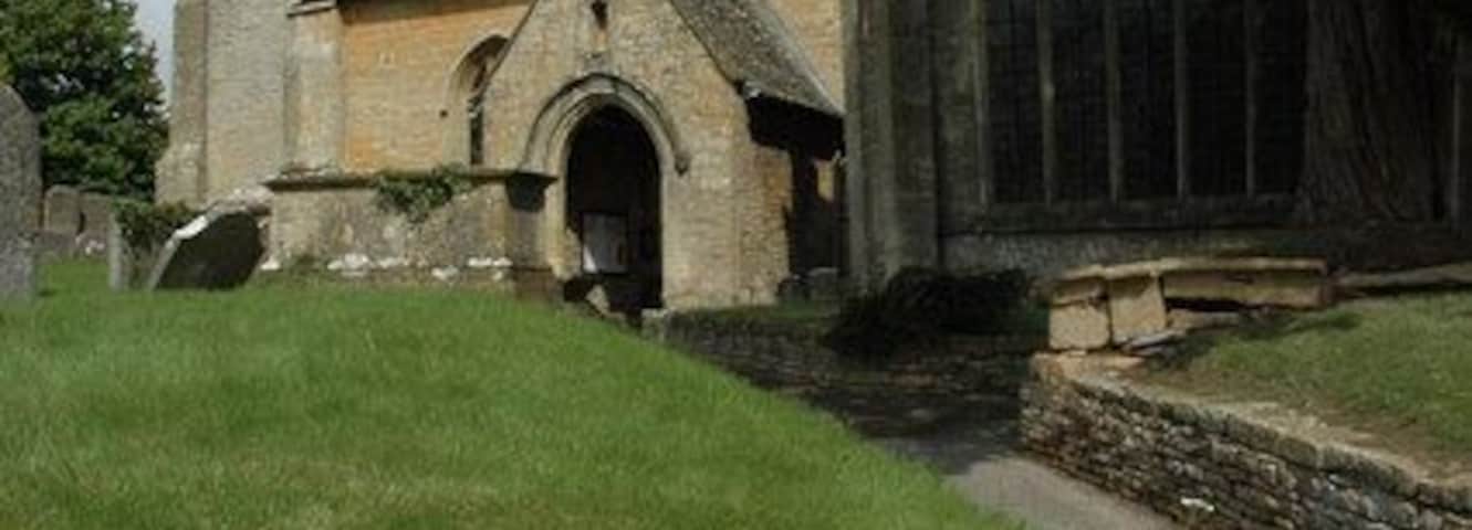West tower and south porch of St James parish church, Longborough, Gloucestershire, seen from the southeast