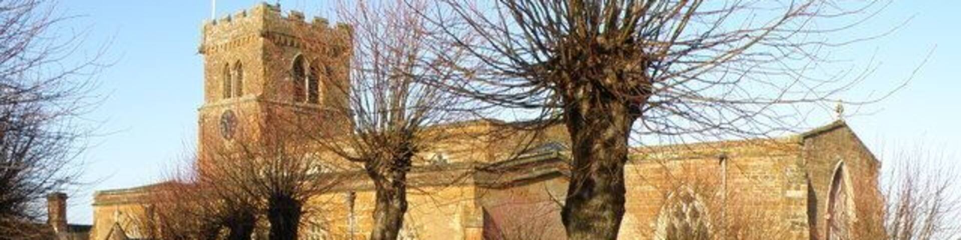 Long Buckby Church A bright December day enhances the colour of the local stone used in the construction of the church.