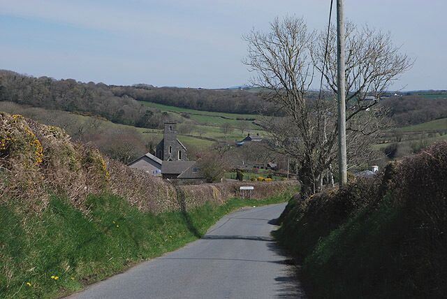 Western approach to Llanddeiniol The minor road connecting with the A487 begins its descent down into the village.