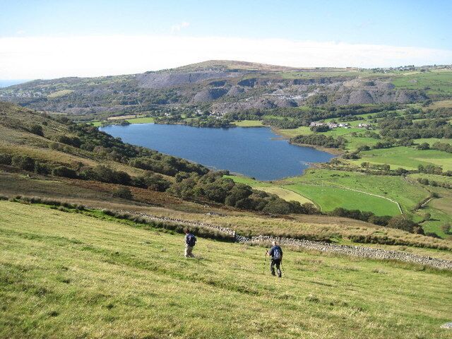 A lake surrounded by hills and fields.