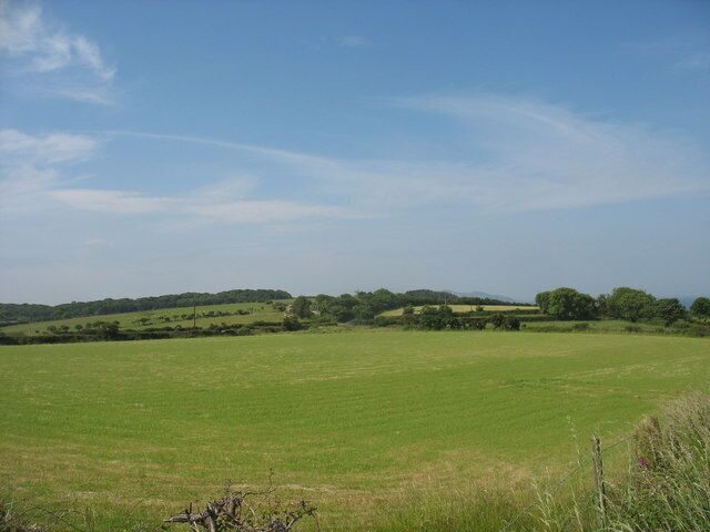 View south-westwards across farmland towards the woodlands of Garreglwyd