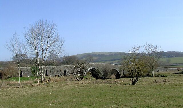 Grazing land at Pont Llanio, near Llanddewi-Brefi, Ceredigion The edge of the Elenydd moorland plateau is on the skyline. The Afon Teifi is bridged here by a long stone bridge with two main arches, and several more smaller ones to accommodate the regular flooding over the banks following heavy prolonged rain. Can some scholar give me a date for the bridge?