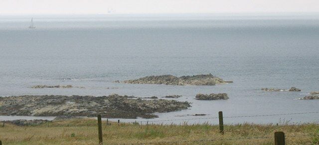 Reefs at Carreg y Fran viewed from the road The 13.50 ex-Holyhead Stena Line Ferry can be seen in the distance.