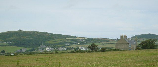 Plas y Gwynt Farmhouse with Llanrhuddlad Church and Mynydd y Garn in the background 1392870