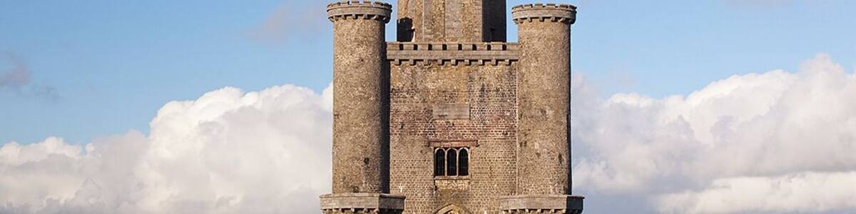 Paxton's Tower (National Trust) is a Neo-Gothic folly / an eyecatcher and banqueting hall / also known as The Nelson Monument / erected by William Paxton in 1806-1809 in honour of Admiral Lord Nelson - killed at the Battle of Trafalgar in 1805. It is a triangular building with a hexagonal castellated roof. On the ground there are three arches to accommodate carriages , with an upper apartment with stained glass windows showing Lord Nelson and scenes from his life. Its hilltop location provides Spectacular views over the Towy (Tywi) valley. William Paxton (1745-1824) spent the fortune he had made in India building a huge neo-classical house Middleton Hall and laying out a park / the hall was destroyed by fire in 1931 / The " National Botanic Garden of Wales" is built on Paxtons Middleton Estate / Leading to the Tower is Paxton's Tower Lodge ( Landmark Trust ) / an early 19C cottage, built for the Tower’s caretaker / SN 541.190 / 7975