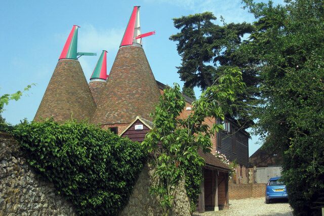 Chart Court Oast, Pluckley Road, Little Chart, Kent It is said the red and green of the cowls were the racing colours of the Beatty family who owned the farm during WWII, when some oasts had their cowls painted black. The oast and neighbouring church were still hit by a doodlebug. Grade II listed http://www.imagesofengland.org.uk/details/default.aspx?id=181055