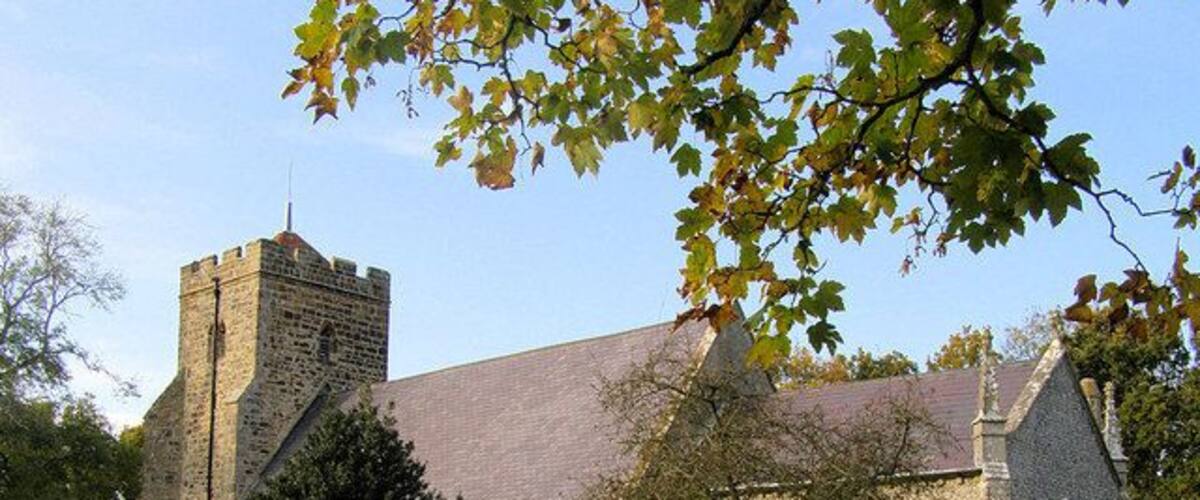A church with a tower and a graveyard.
