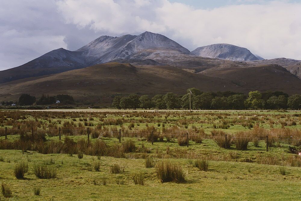 Field near Culaneilan farm, Incheril Taken from the old public car park near the farm. The drainage ditch in the foreground is one of several which help keep the land reasonably dry. Beyond the field a line of light coloured stones marks where the A' Ghairbhe river meets the Abhainn Bruachaig to form the Kinlochewe River. Beinn Eighe crowns the horizon.