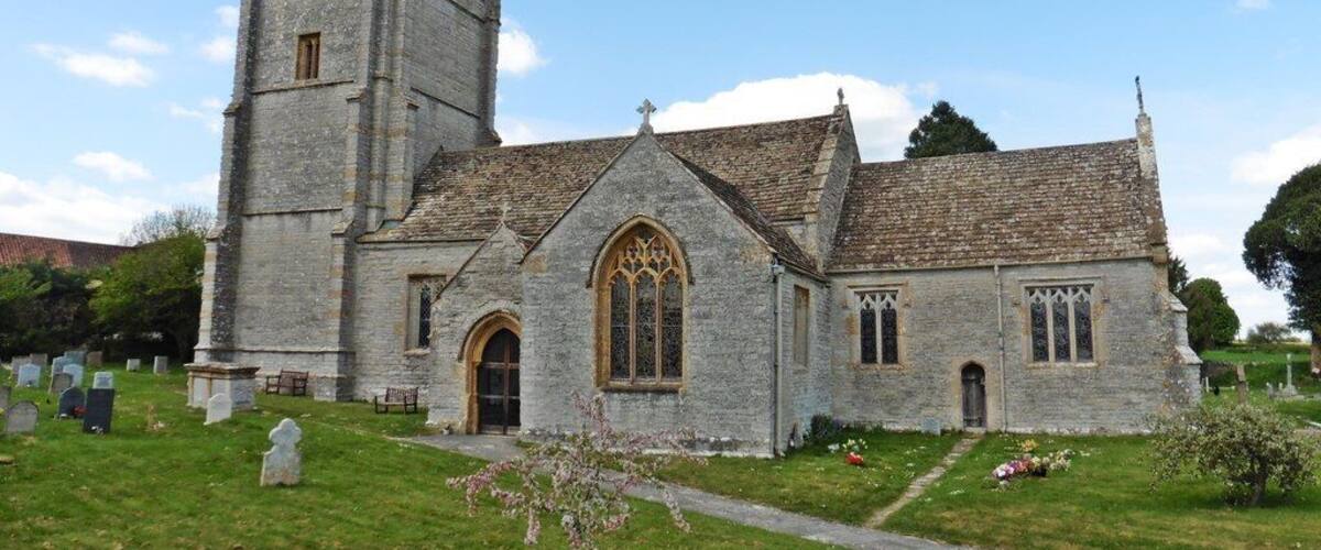 A historic church with a tall tower and arched windows.