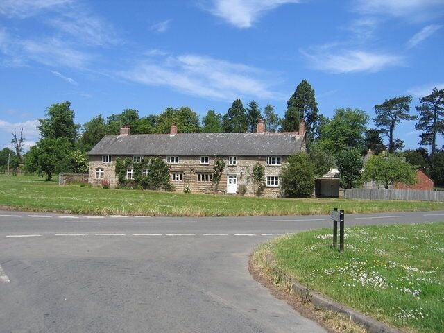 Little Kineton. A row of cottages by the village green with some interesting patterned stonework.